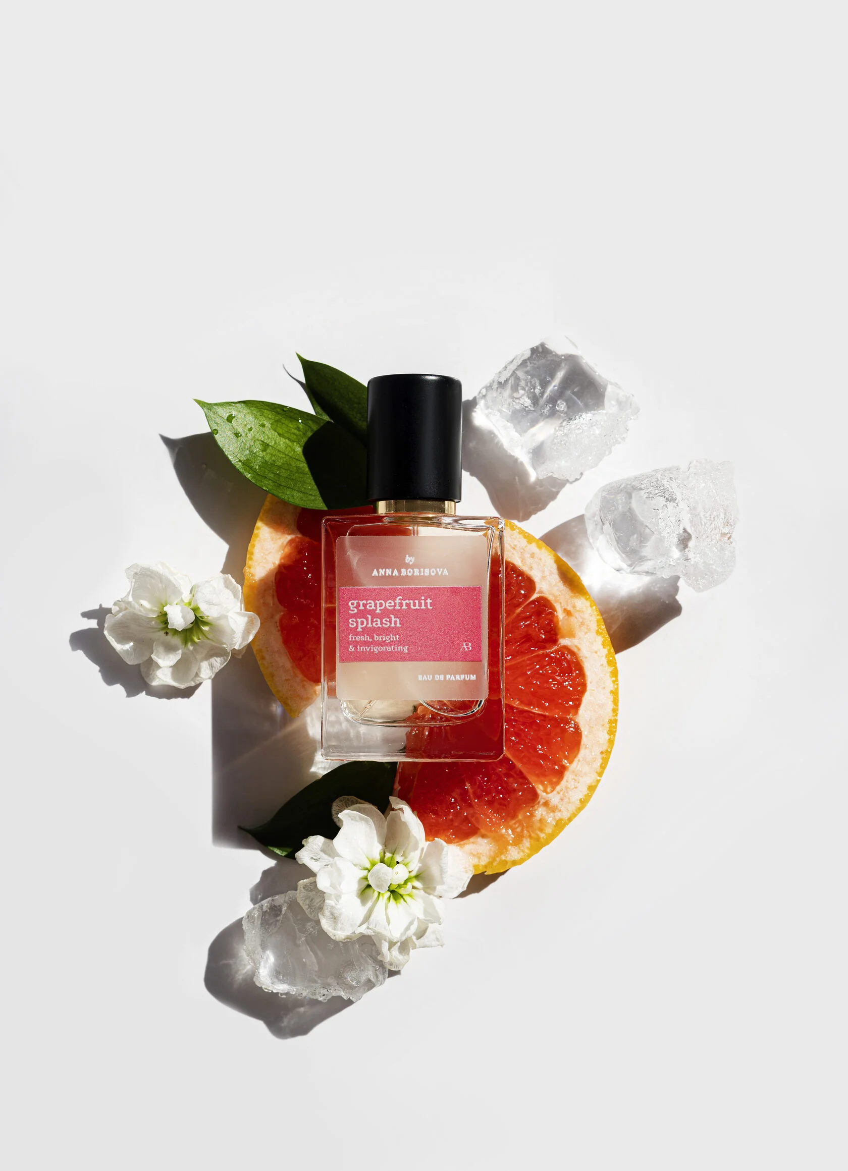 Aroma Parfum perfume bottle with fruits and flowers, showcasing the brand's signature visual style